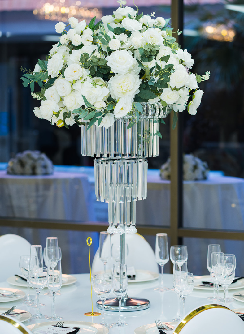 A bride and groom are holding hands during their wedding ceremony.