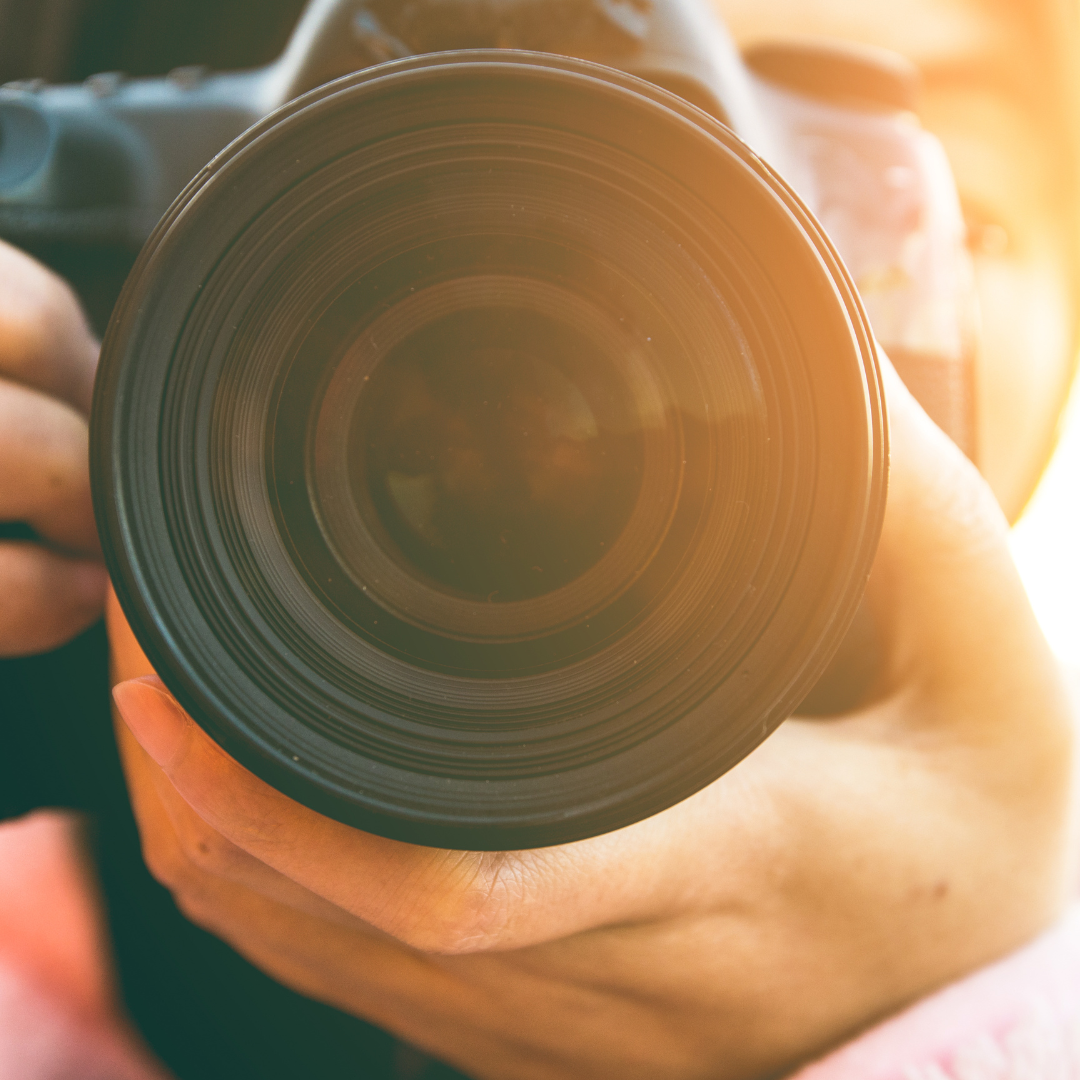 A person is taking a picture with a camera lens